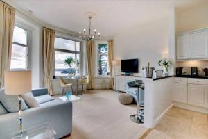 uma sala de estar com um sofá e uma mesa em 180° Water View Apartment - Simply Amazing em Torquay