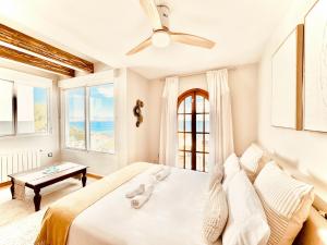 a bedroom with a bed and a view of the ocean at Casa Natura Carabassi Beach in Gran Alacant