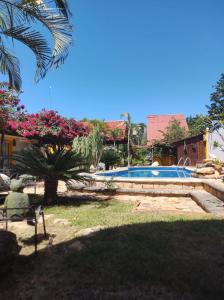 a person sitting in a chair next to a swimming pool at Quinta Rosita in Ticul