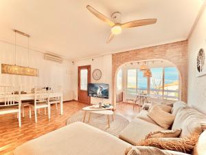 a living room with a couch and a ceiling fan at Casa Natura Carabassi Beach in Gran Alacant