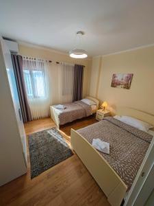 a small room with two beds and a room with at Anoe City Center Apartment in Shkodër