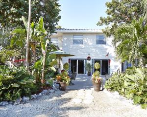 a house with trees and plants in front of it at Seascape Resort & Marina in Marathon