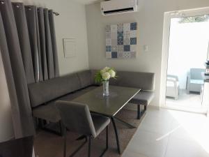 a living room with a table and a couch at Apricity Suites Aruba in Noord