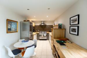 a kitchen with a table and some chairs and a table at BIRDS EDGE COTTAGE - Luxury 2 Bedroom Cottage with Amazing Views, Near Holmfirth in Yorkshire in Denby Dale