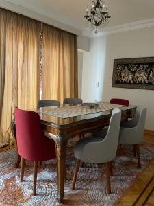 開羅的住宿－Maadi Serenity:3BR Inviting Home，一间带木桌和椅子的用餐室