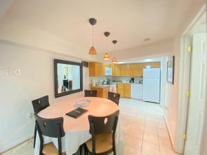a kitchen and dining room with a table and chairs at COMFY Basement Home 2 Bdrm1Den 3Queen Beds in Washington, D.C.