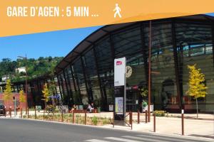 a large glass building with a sign in front of it at Loc'Nuit - Appartements Tout Confort - Hyper Centre AGEN in Agen