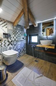 a bathroom with a toilet and a sink at Wild Lavender Mountain Resort in Papigko