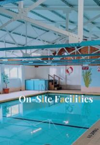a large swimming pool in a building at 44 Gower holiday village Ty Gŵyr Cosy 2 bedroom Chalet in Swansea