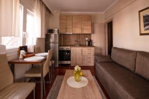 a small living room with a couch and a table at Emi's beach apartment in Nea Kalikratia
