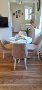 a dining room with a table and chairs at Apartman Bonsai in Subotica +14 photos