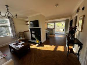 a living room with a couch and a table at Sunnybank cottage in Alnwick