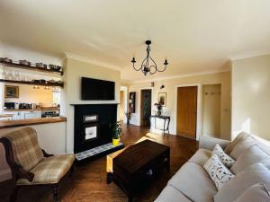 a living room with a couch and a fireplace at Sunnybank cottage in Alnwick +5 photos