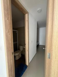 an open door to a bathroom with a toilet at CASA AMOBLADA CERCA A LA BASILICA in Club del Comercio