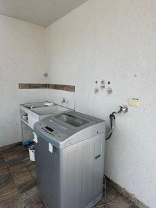 a laundry room with a washer and a sink at CASA AMOBLADA CERCA A LA BASILICA in Club del Comercio