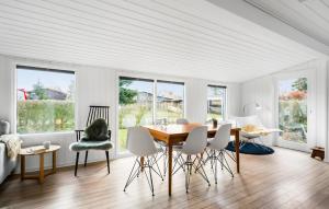 a dining room with a table and chairs at 3 Bedroom Beautiful Home In Juelsminde in Juelsminde
