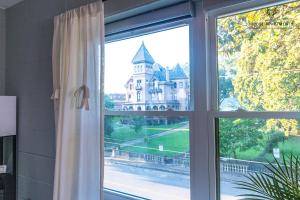 a window with a view of a castle at The Moose #7 - Instaworthy Studio with Amazing Views, Free Parking & Heated King Bed in Memphis
