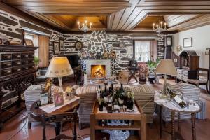 a living room filled with furniture and a fireplace at Quinta de Marrocos in Peso da Régua