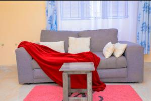 a red blanket sitting on top of a couch at Nuri Homes in Kisii