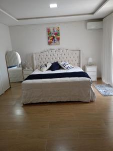 a bedroom with a large bed with pillows on it at Pousada Donatella in Paranaguá