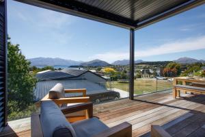 a living room with a view of the mountains at Super Central in Wanaka in Wanaka