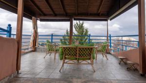 a patio with a table and chairs on a balcony at Xristina's sofita in Kozani