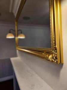 a gold mirror on a counter in a room at Elegant 3 Bed Flat in Marylebone, London in London