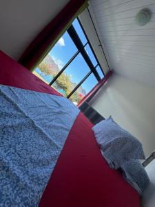 a bed in a room with a large window at Taiohae Bay in Nuku Hiva