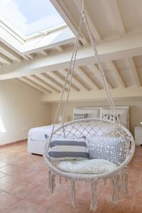 a swing in a bedroom with a bed at White Attic Lucca in Lucca