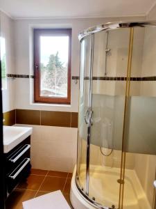 a bathroom with a shower and a sink at Apartament BEACH VIBES Nessebar in Nesebar