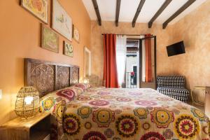 a bedroom with a large bed and a chair at Hostal Artistic B&B in Madrid