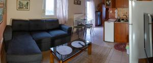 a living room with a couch and a table at Xristina's sofita in Kozani
