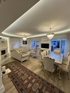 a living room with a couch and a table at Royal Villa in Forest in Dosemealti