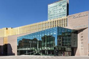 a large glass building with a tall building at Charleville E centre - gare - aéroport in Charleroi