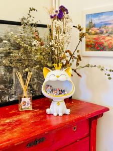 a cat toy sitting on a table with a bowl on it at Une chambre chez moi,A guest room in my home,20mins to Paris in Colombes