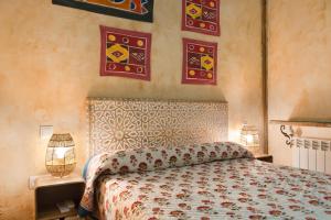 a bedroom with a bed and paintings on the wall at Hostal Artistic B&B in Madrid +122 photos