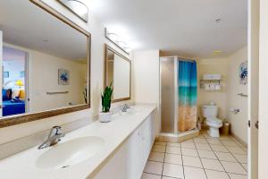 a bathroom with a sink and a toilet and a mirror at Daytona Beach Resort 1216 in Daytona Beach