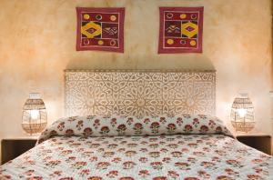 a bedroom with a bed and two pictures on the wall at Hostal Artistic B&B in Madrid