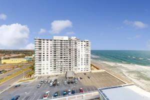 an aerial view of a large white building next to the ocean at Daytona Beach Resort 1216 in Daytona Beach