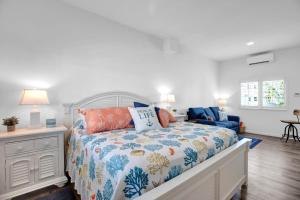 a bedroom with a bed and a blue chair at Carney's Reef NEW 1B 1B Pool Patio in Marathon