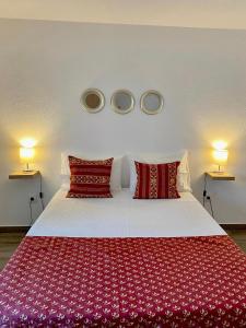 a bedroom with a large bed with red pillows at Quinta do Miradouro in Portalegre +47 photos