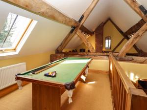 a room with a pool table in a attic at The Granary in Shrewsbury