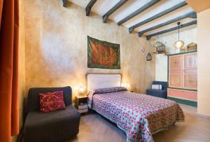 a bedroom with a bed and a chair in a room at Hostal Artistic B&B in Madrid