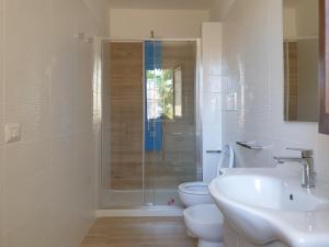 a bathroom with a shower and a toilet and a sink at La Casa di Antonio Rooms in Palinuro