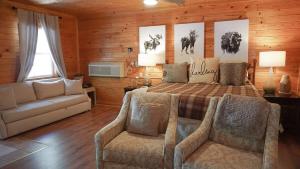 a bedroom with a bed and two chairs and a couch at The Cave at Shady Woods - 1 Bedroom Studio - Walk to Downtown! in Gatlinburg