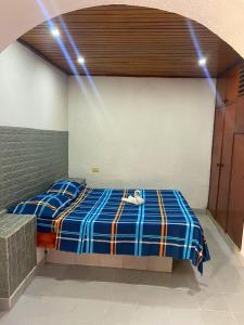 a bedroom with a bed with lights on it at Hotel brisas del mar 2022 in Catia La Mar