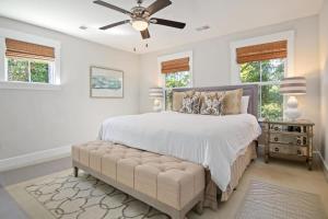 a bedroom with a bed and a ceiling fan at Mt Pleasant Beach Retreat- Mins to Sullivan's IOP in Charleston