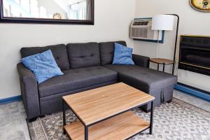 a living room with a couch and a table at Lighthouse Villa @ The Reef in Chincoteague