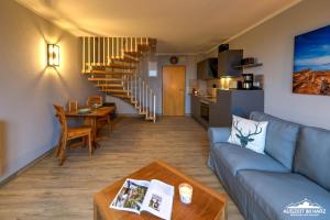 a living room with a couch and a table at Auszeit-im-Harz Haus 5 Wohnung 36 in Stiege
