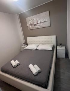 a bedroom with a large bed with two pillows at Apartmani Cvitanovic in Baška Voda